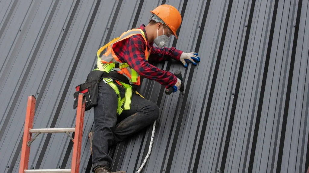 Maintenance being performed on a metal roof in Albuquerque