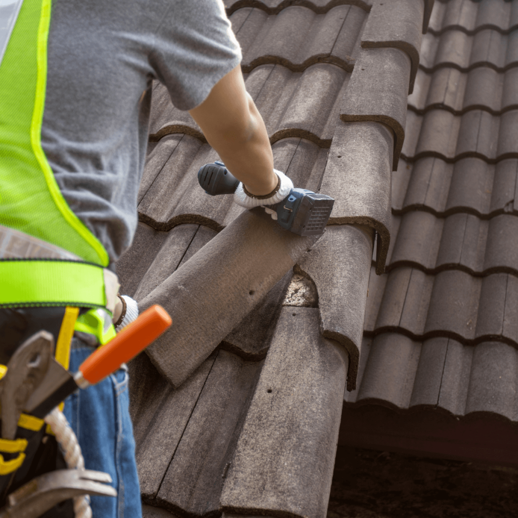 Professional roofer inspecting a clay tile roof in Albuquerque to identify damage and ensure long-term protection.