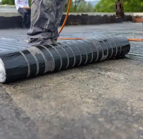 Technician installing a replacement modified bitumen roof
