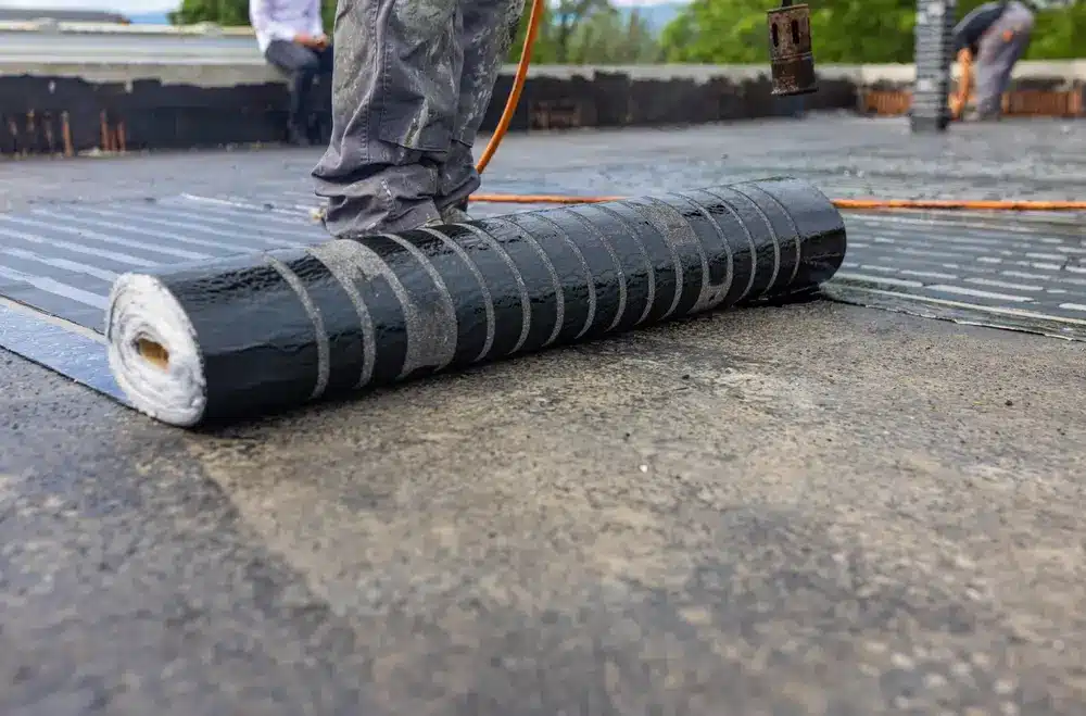 Technician installing a replacement modified bitumen roof