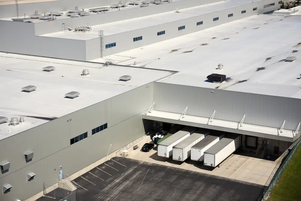 Professional commercial roofing contractor inspecting a flat roof in Albuquerque, NM