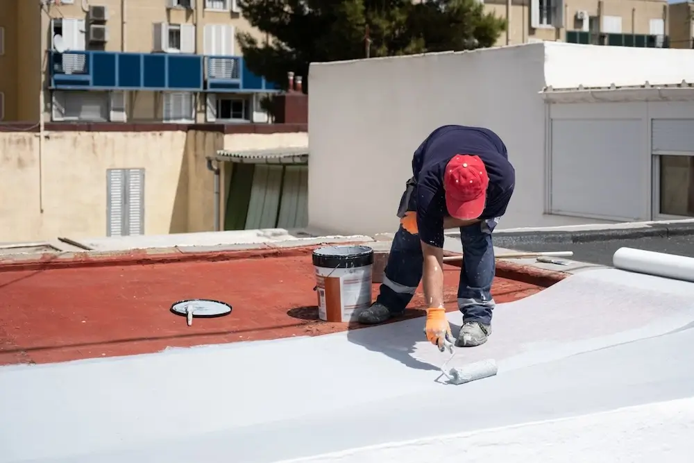 Roofing contractor inspecting a flat roof in Los Lunas, NM to determine whether repair or replacement is needed
